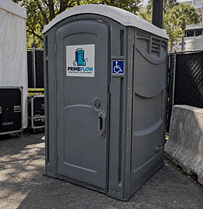 Wheelchair accessible portable restroom with the accessibility symbol on the door