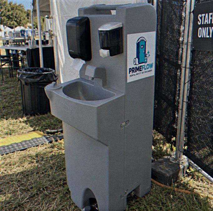 Free-standing hand wash station with two basins and soap dispensers