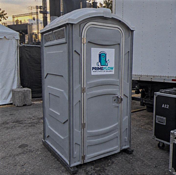 Portable restroom placed on asphalt at a working site
