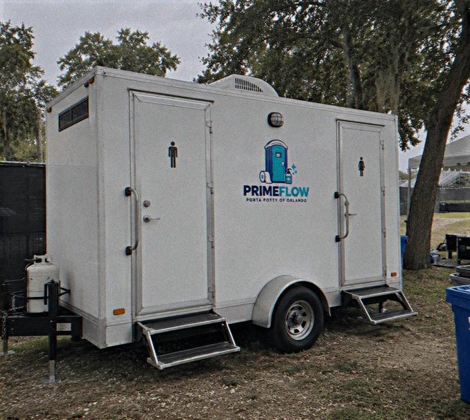 Restroom trailer with two doors and fold-out steps seen from the side
